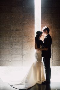 A bride and groom holding each other