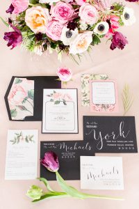 A set of wedding invitations and a floral arrangement