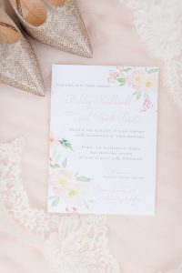 A wedding invitation and a pair of shoes