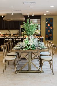 A wooden dining table with beautiful centerpieces