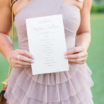A woman holding a wedding invitation