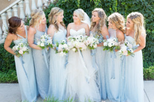 A group of bridesmaids looking at the bride