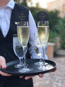 A waiter serving up champagne and water