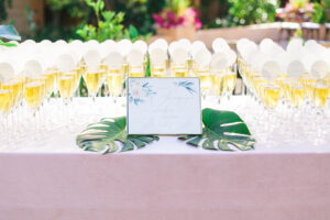 An invitation surrounded by champagne glasses