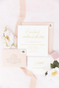 A pink wedding invitation with flowers