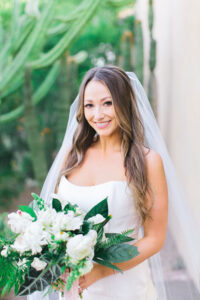 A smiling bride holding a bouquet